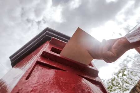 closeup-on-a-male-hand-putting-a-letter-in-a-red-l-2023-11-27-05-18-59-utc