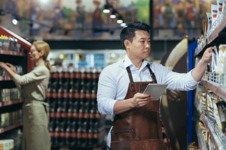 two-workers-in-a-supermarket-in-the-grocery-depart-2023-11-27-04-57-37-utc