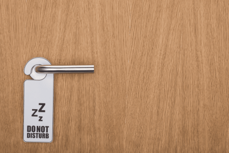 wooden-hotel-room-door-with-do-no-disturb-sign-on-2023-11-27-04-50-21-utc